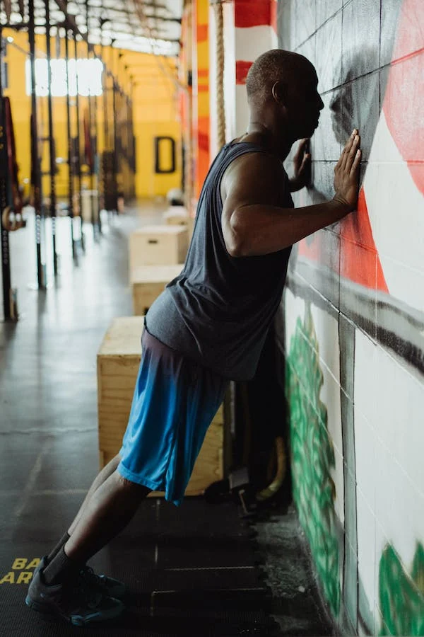 A man doing wall push-ups